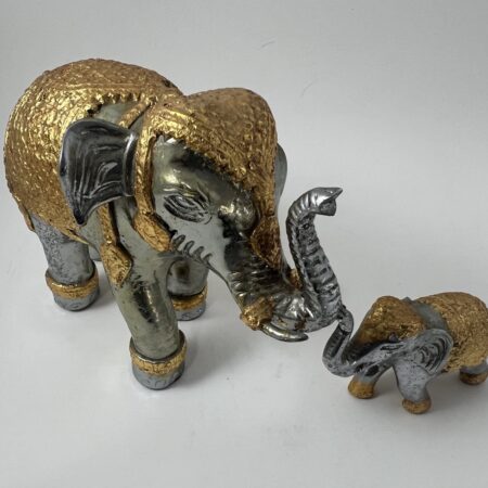 Authentic Thai elephant figurine purchased in Bangkok in 1995, featuring hand-applied gold leaf and traditional craftsmanship. A unique, culturally significant decorative piece. ￼