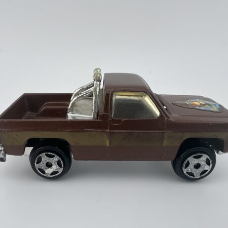 brown pickup truck diecast toy with chrome engine detail side view left profile vintage model