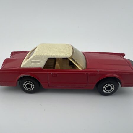 red convertible diecast car with white roof side view left profile vintage model