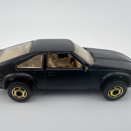 black coupe diecast car vintage toy side view left profile gold wheels classic style