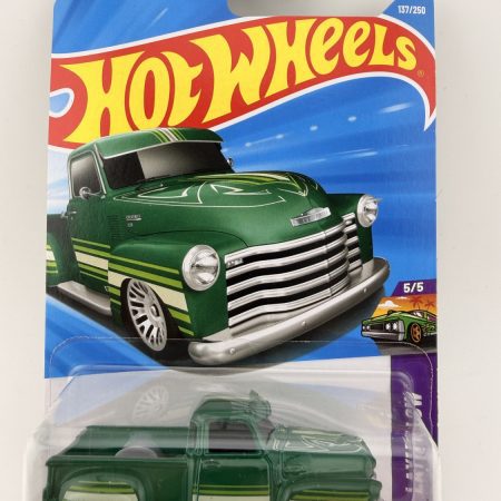 Hot Wheels La Troca Layin Low diecast car in original packaging with colorful artwork and Mattel branding, 1:64 scale collectible